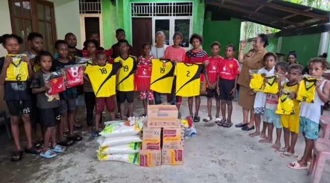 Sekwan DPR Papua, Juliana Waromi saat menyerahkan bantuan kostum bola dan bahan pangan di Gereja Santo Petrus Koya Tengah / rbt