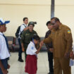 Seorang siswa bersalaman dengan Asisten 1 Setda Papua, Yohanes Walilo / Papua.go.id