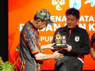 Manajer Persipura, Owen Rahadian menerima plakat dari Bank Papua